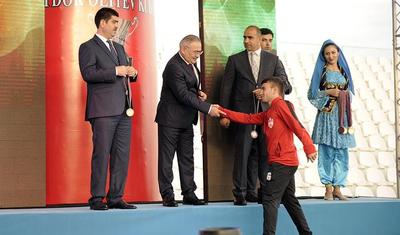 Azərbaycanlı məşqçi uşağı pencəyinin altında yağışdan qorudu - FOTOLAR
