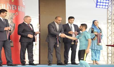 Azərbaycanlı məşqçi uşağı pencəyinin altında yağışdan qorudu - FOTOLAR